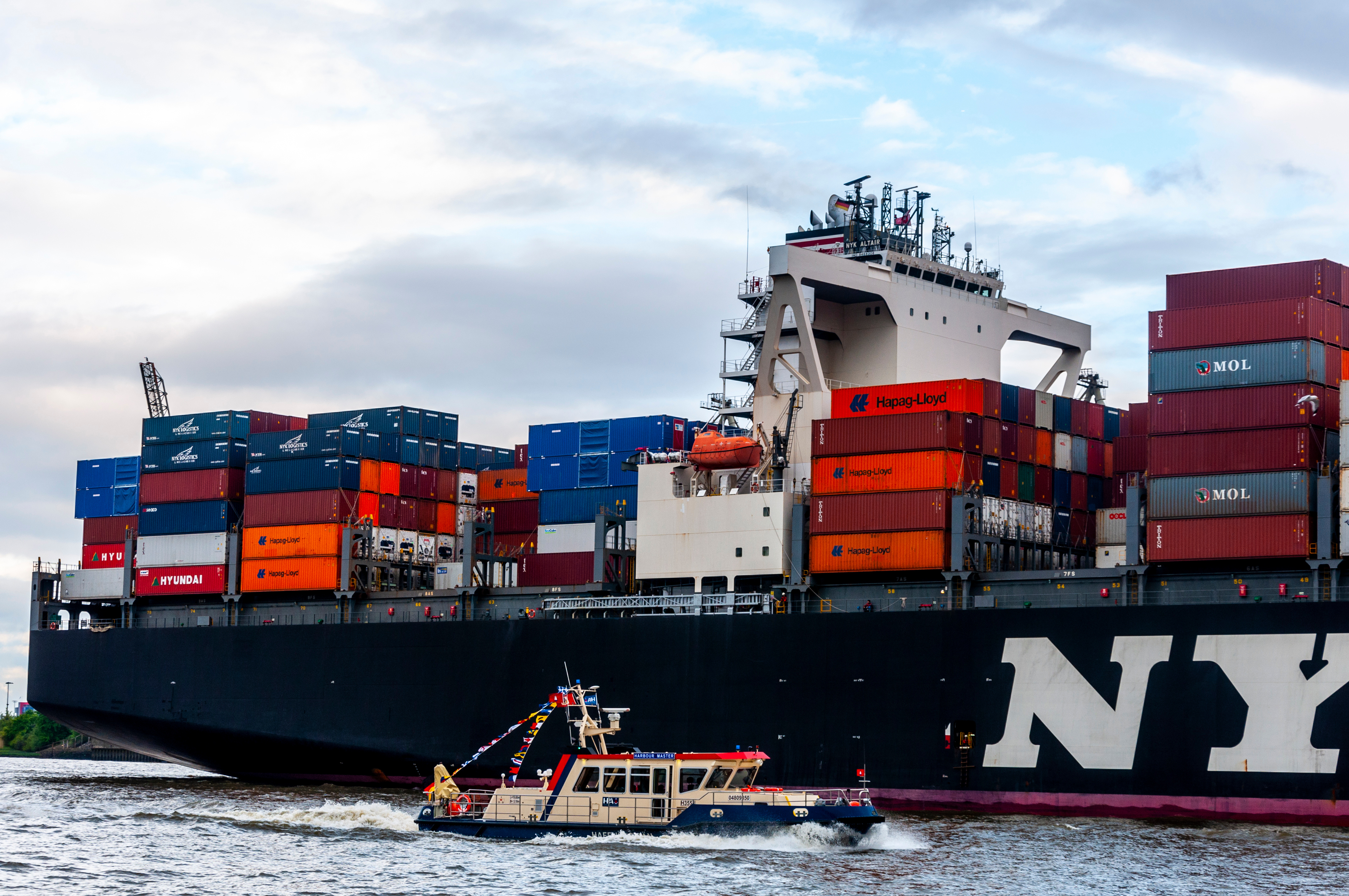 Small boat and cargo ship with containers